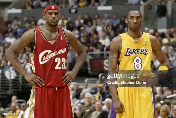 LeBron James of the Cleveland Cavaliers and Kobe Bryant of the Los Angeles Lakers look on January 12, 2004 at Staples Center in Los Angeles,...