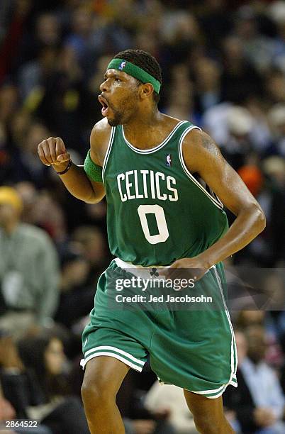 Walter McCarty of the Boston Celtics runs down the court and celebrates during the game against the Golden State Warriors at the Arena in Oakland on...