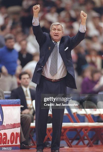 Coach Dean Smith of the University of North Carolina Tarheels celebrates after a basket during a playoff game against the Louisville Cardinals at the...