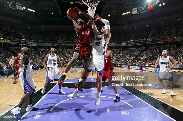 Eddie Jones of the Miami Heat shoots over Brad Miller of the Sacramento Kings on January 13, 2004 at Arco Arena in Sacramento, California. NOTE TO...