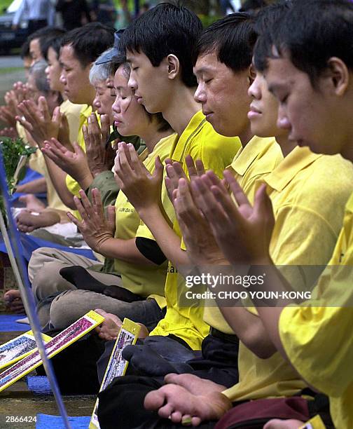 Chinese Indonesian, and Indonesian Falun Gong practitioners protest with portraits of victims who died by suppression of Chinese government, in front...