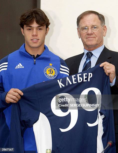 Yozheff Sabo vice-president of Dynamo Kiev holds with Kleber his new Dynamo team shirt during his presentation after signing a five year contract...
