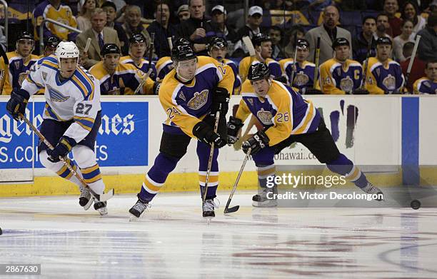 Alexander Frolov of the Los Angeles Kings skates and passes the puck in the neutral zone during the game against the St. Louis Blues on November 15,...