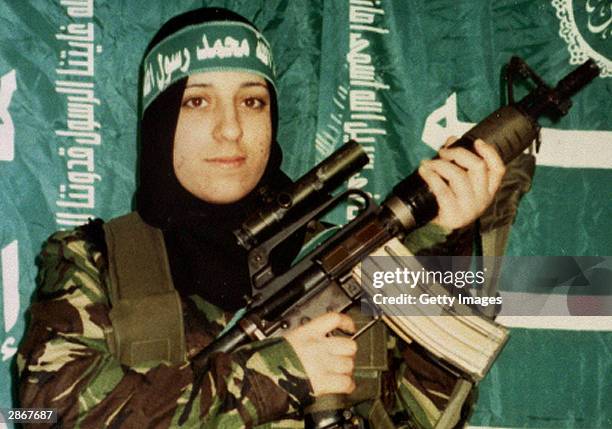 In this undated handout image, Reem Slaleh Raiyshi, a mother of two children from Gaza stands holding a gun. Raiyshi was named as the woman who blew...