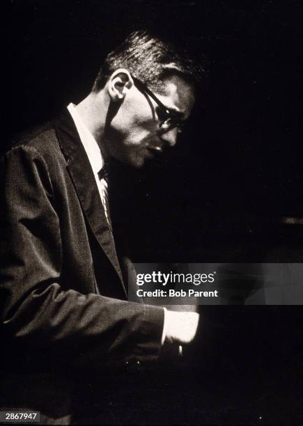 American jazz pianist Bill Evans performs in profile during a concert at the Showplace, New York City, July 31, 1959.
