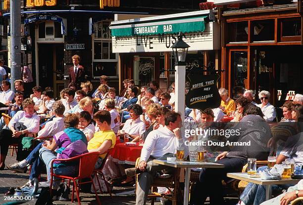 holland,amsterdam,rembrandtsplein, people at outdoor cafe tables - crowded cafe stock pictures, royalty-free photos & images