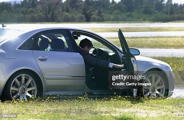 Crown Prince Frederik of Denmark and his Tasmanian-born fiancee Mary Donaldson drive away a car at Hobart Airport on January 14, 2004 in...
