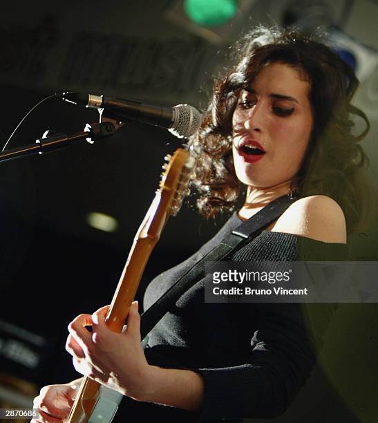 Singer Amy Winehouse performs live on stage at HMV Oxford Street on January 15, 2004 in London.