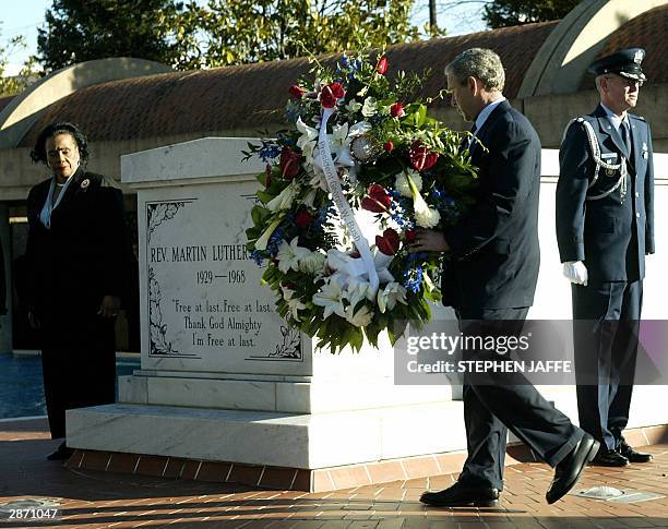 President George W. Bush lays at wreath at the grave of Dr. Martin Luther King, Jr., as his widow Coretta Scott King looks on 15 January at the King...