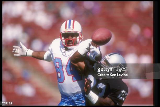 Wide receiver Haywood Jeffires of the Houston Oilers and Los Angeles Raiders defensive back Sam Seale fight for the ball during a pre-season game at...