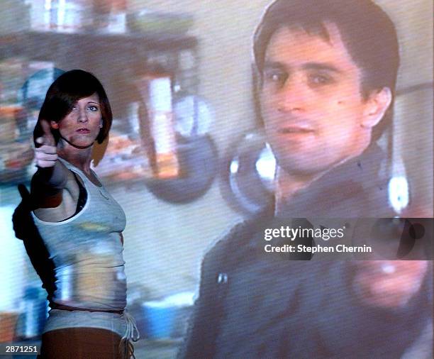 Anastasia Fite, the originator of "movieoke" acts out a scene of Taxidriver with Robert De Niro at the Den of Cin bar January 14, 2003 in New York...