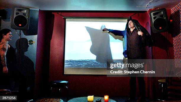 Bar goer acts out a scene from French and Saunders, a British comedy show at the Den of Cin bar January 14, 2003 in New York City. "Movieoke" a...