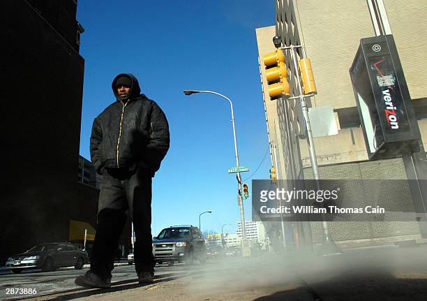 An unidetified woman is bundled up to protect herself from the frigid cold temperatures as she walks January 16, 2004 in Philadelphia, Pennsylvania....