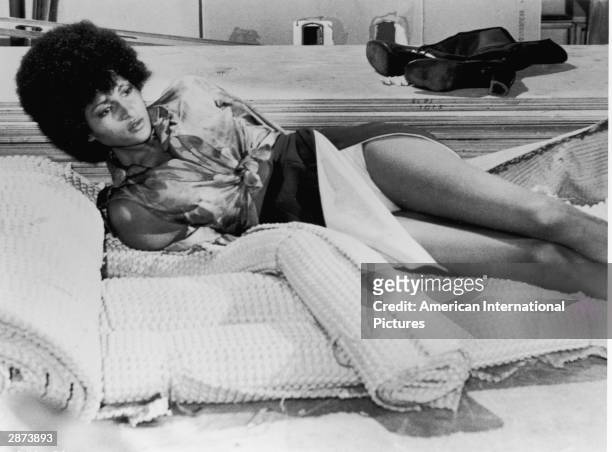 American actor Pam Grier lays on a mat with her hands tied behind her back, in a still from 'Foxy Brown,' directed by Jack Hill, 1974.