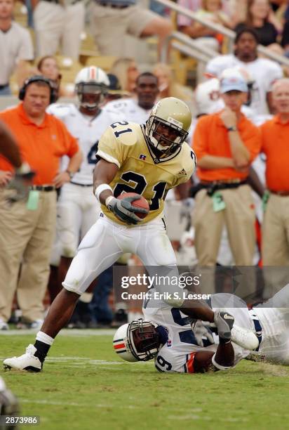 Wide receiver Jonathan Smith of the Georgia Tech Yellow Jackets attempts to break loose from cornerback Montavis Pitts of the Auburn Tigers during...