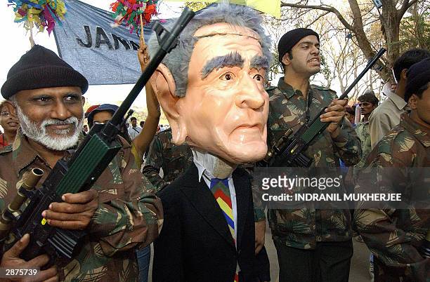 Indian activists, acting as freedom fighters, lead a fellow activist enacting US President George W. Bush being arrested at the 2004 World Social...