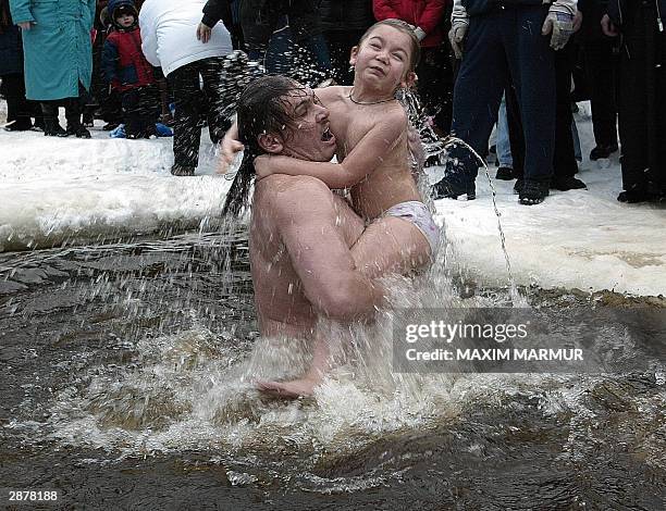 Russian believers emerge from in the icy waters of the Moskva river during the celebrations of the holiday of Epiphany where believers demonstrate...