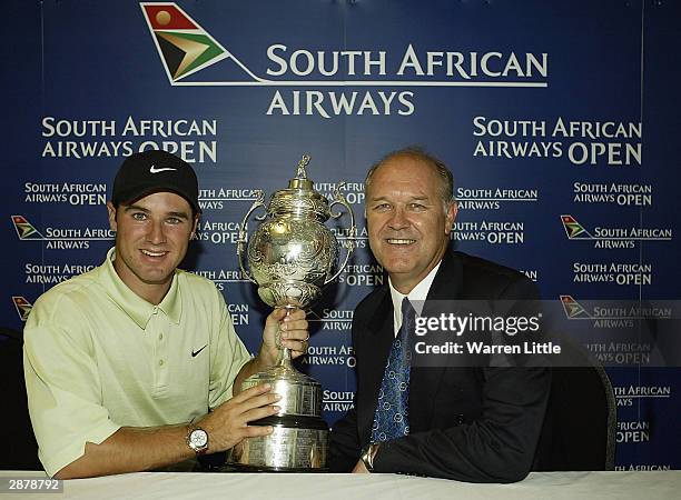 Trevor Immelman of South Africa poses with his father Johann, Commissioner of the sunshine tour, after winning the South African Airways Open at the...