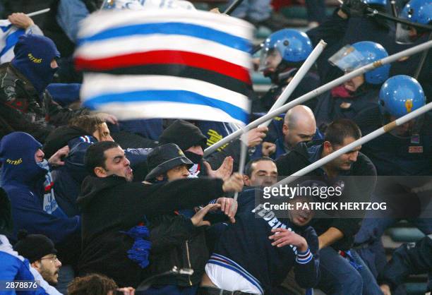 Sampdoria Genoa's fans clash with riot police during the Italian Serie A soccer match between AS Roma and Sampdoria at the Olympic stadium in Rome....