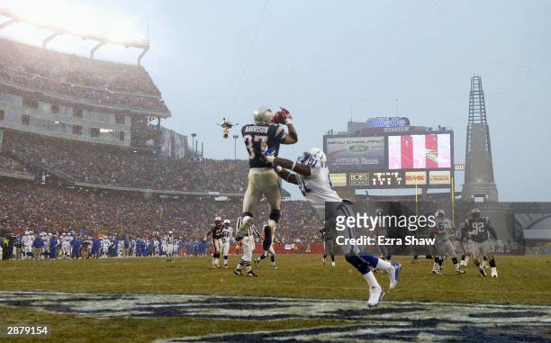 Safety Rodney Harrison of the New England Patriots intercepts the ball in front of tight end Marcus Pollard of the Indianapolis Colts in the AFC...