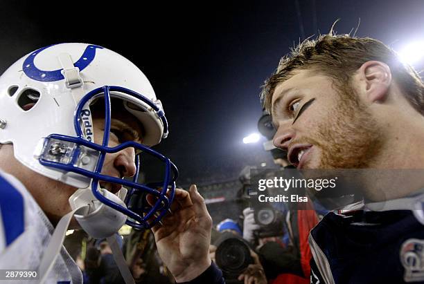 Quarterback Tom Brady of the New England Patriots and quarterback Peyton Manning of the Indianapolis Colts greet each other on the field after the...