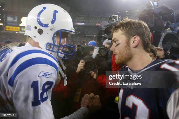 Quarterback Tom Brady of the New England Patriots and quarterback Peyton Manning of the Indianapolis Colts greet each other on the field after the...