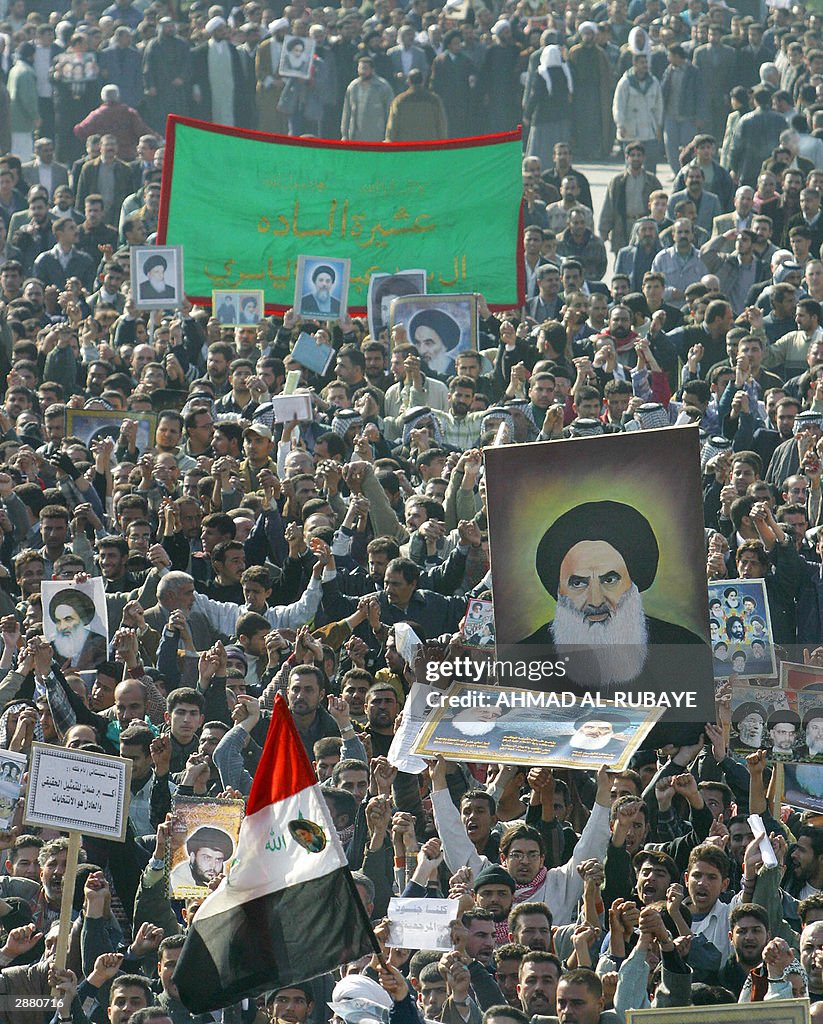 Muslims In Iraq Thousands of Iraqi Shiite Muslims waving an Iraqi flag and pictures ...