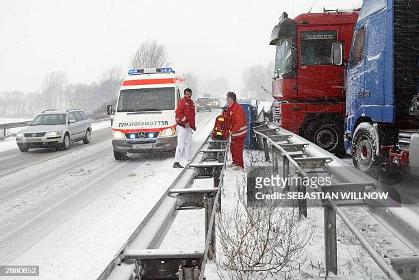Ambulance men approach the area of an accident on the highway A14 between eastern towns of Dresden and Leipzig, where heavy snowfalls and sudden...