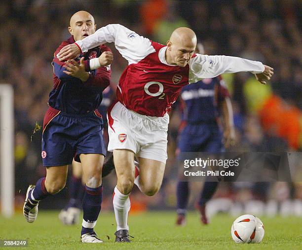Pascal Cygan of Arsenal battles for the ball with Massimo Maccarone of Middlesbrough during the Carling Cup Semi-Final first leg match between...