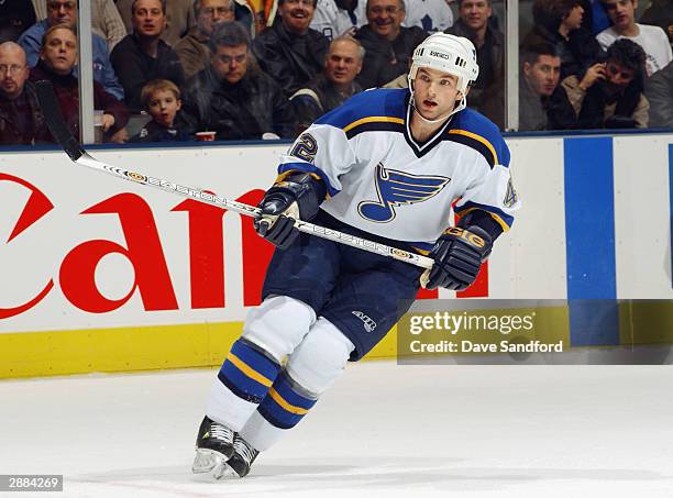 Mark Rycroft of the St. Louis Blues eyes the play as he skates against the Toronto Maple Leafs at Air Canada Centre on December 9, 2003 in Toronto,...