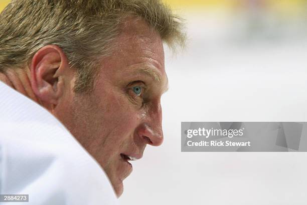 Right wing Brett Hull of the Detroit Red Wings watches the action during the game against the Buffalo Sabres on December 10, 2003 at HSBC Arena in...