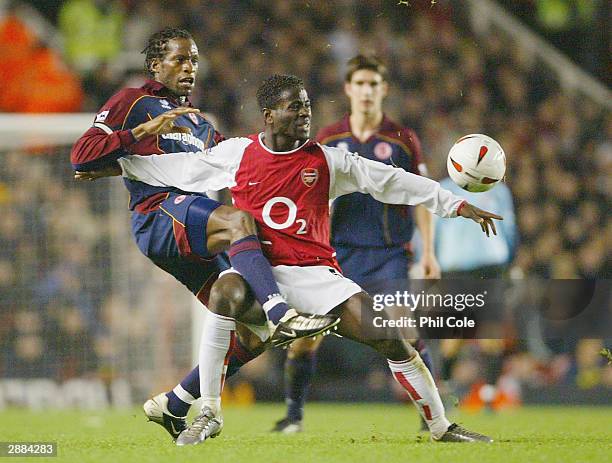 Quincy Owusu-Abeyie of Arsenal battles for the ball with Ugo Ehiogu of Middlesbrough during the Carling Cup Semi-Final first leg match between...