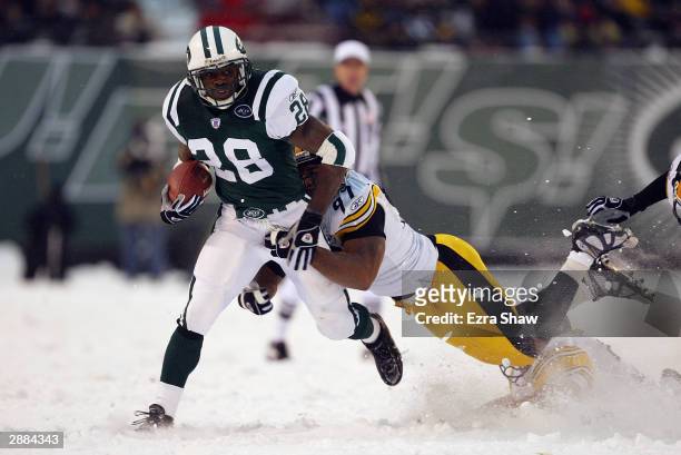 Running back Curtis Martin of the New York Jets is tackled by linebacker Kendrell Bell of the Pittsburgh Steelers during the game at Giant Stadium on...
