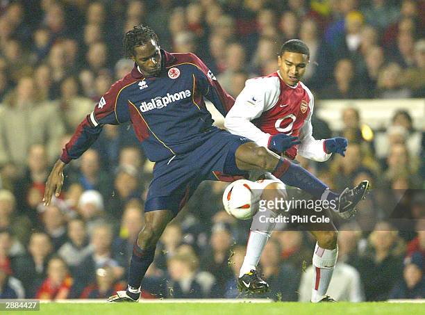 Ugo Ehiogu of Middlesbrough battles for the ball with Jerome Thomas of Arsenal during the Carling Cup Semi-Final first leg match between Arsenal and...
