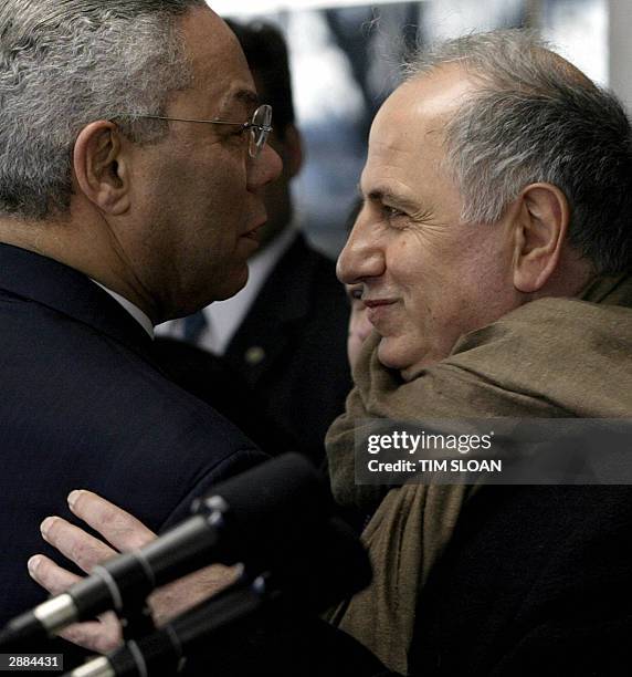 Secretary of State Colin Powell embraces Iraqi Governing Council member Dr. Ahmed Chalabi after a press conference at the State Department 20 January...