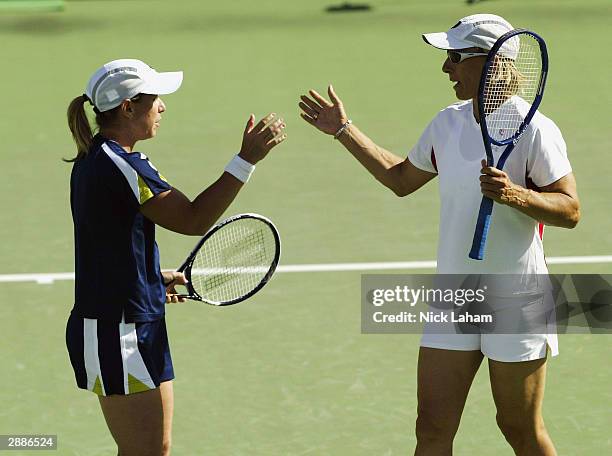 Martina Navratilova of the USA celebrates a shot with doubles partner Lisa Raymond of the USA during day three of the Australian Open Grand Slam at...