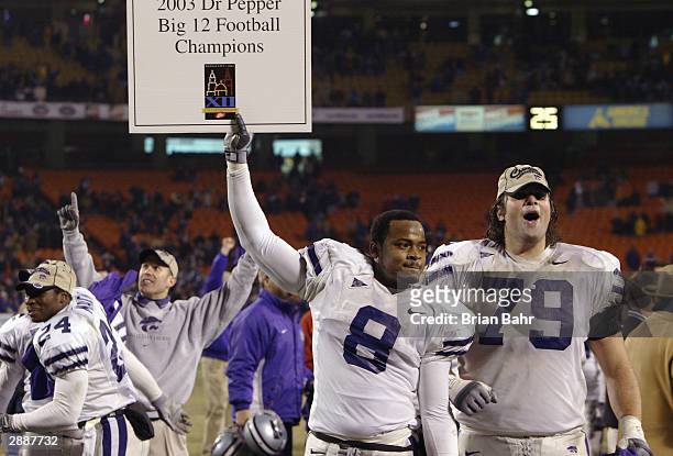 Defensive back James McGill and tackle Jon Doty of the Kansas State Wildcats celebrate after defeating the Oklahoma Sooners in the Dr. Pepper Big 12...