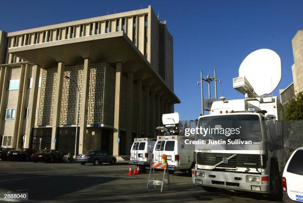 Television trucks line up outside of the San Mateo County Superior court January 21, 2004 in Redwood City, California. A judge Tuesday ordered the...