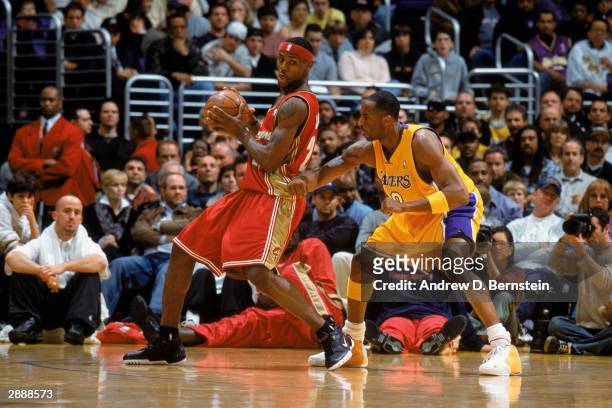 LeBron James of the Cleveland Cavaliers guards the ball against Kobe Bryant of the Los Angeles Lakers during the NBA game at Staples Center on...