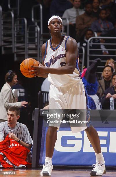 Kwame Brown of the Washington Wizards holds the ball during the game against the Houston Rockets at MCI Center on January 13, 2004 in Washington,...