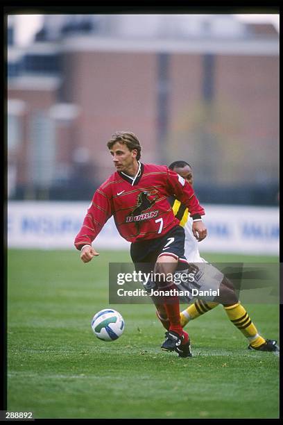 Mark Santel of the Dallas Burn runs down the field at Doctor Khumalo of the Columbus Crew chases him during a game at Ohio Stadium in Columbus, Ohio....