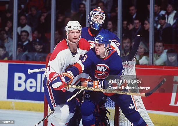 KIRK MULLER OF THE MONTREAL CANADIENS BATTLES FOR POSITION IN FRONT OF THE NEW YORK ISLANDERS NET DURING THEIR GAME AT THE MONTREAL FORUM IN...
