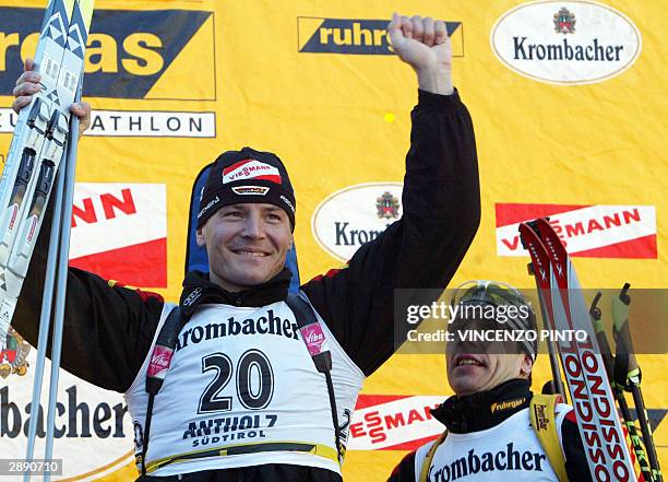 German Sven Fisher celebrates on the podium after winning the men's biathlon 20 km individual event part of the Biathlon World Cup in Anterselva 22...