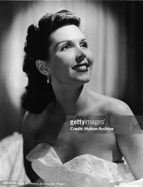Studio portrait of American actor and dancer Ann Miller in a strapless lace gown and with teardrop earrings, circa 1940s.