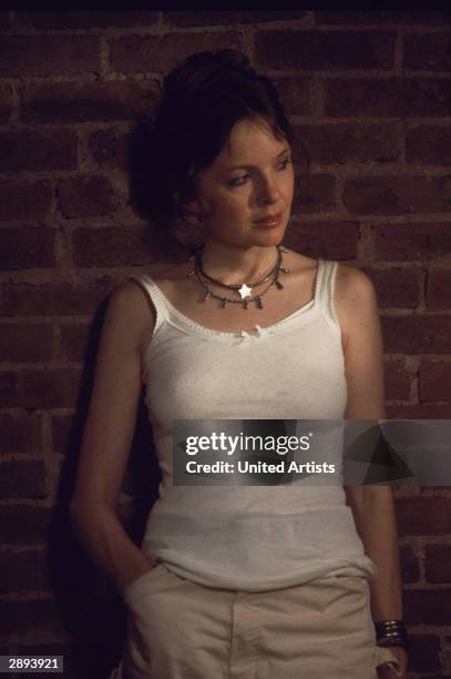 American actor Diane Keaton wears a white tank top and leans against a brick wall in a scene from 'Annie Hall,' directed by Woody Allen, New York,...