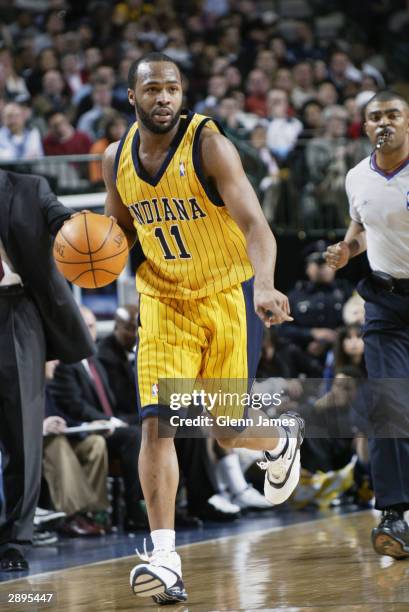 Jamaal Tinsley of the Indiana Pacers drives against the Dallas Mavericks during the game at American Airlines Arena on January 9, 2004 in Dallas,...