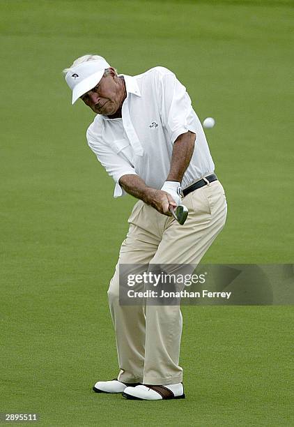 Arnold Palmer chips onto the 8th hole during the first round of the Champions Tour Mastercard Championship on January 23, 2004 at the Hualalai Golf...