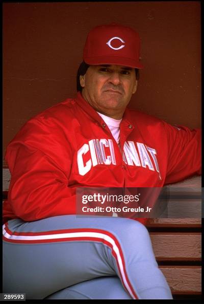 Red Roses Manager Manager Pete Rose of the Cincinnati Reds looks on from the dugout at ...