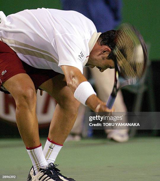 Albert Costa of Spain slams his racket onto the court in anger during his loss to Hicham Arazi of Morocco in their men's singles third round match at...