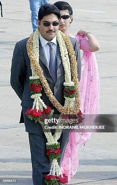 Nepal's Crown Prince Paras Bir Bikram Shah Dev and Princess Himani Rajyalakshmi Dev walk towards their car after their arrival in Bangalore, 25...